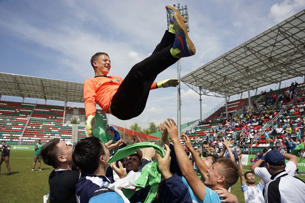 Niños celebrando un campeonato de fútbol.